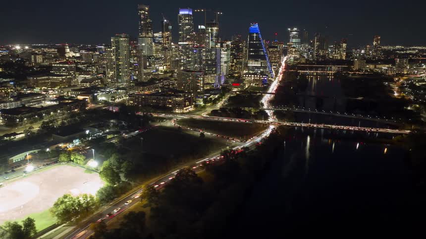 Panorama of a metropolis illuminated at night and with a sea canal
