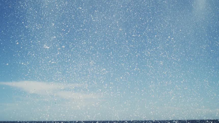 Water and dense foam falling into an ocean