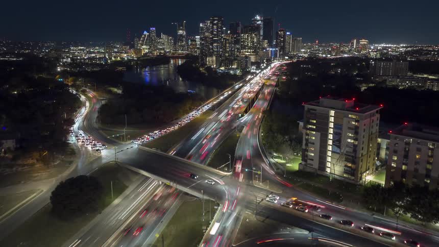 Aerial view of heavy vehicle traffic on overpasses in a metropolis at night