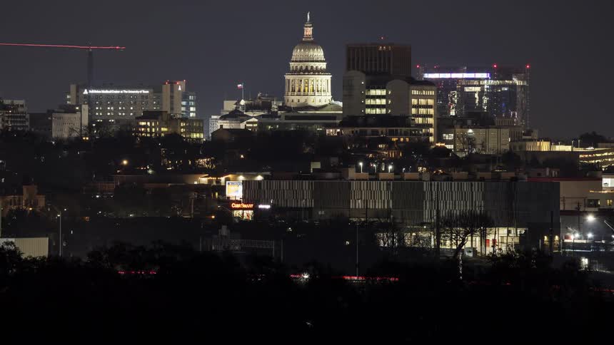 A city is lit up at night with bright lights