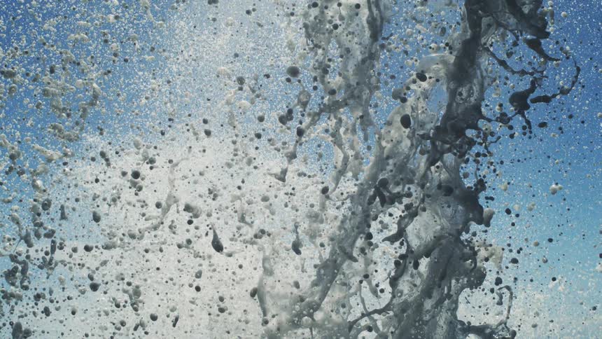 Jet of water rising against a blue sky during daytime
