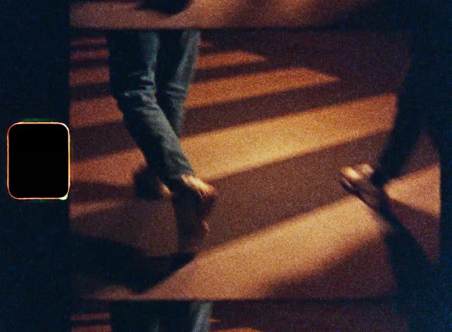 Legs of two people crossing a pedestrian crossing at night