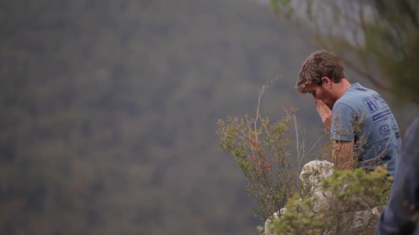 A person holding onto a rope