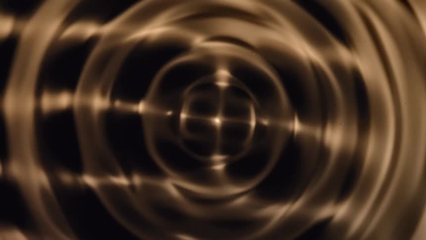 Water Cymatics, Abstract golden spiral dissolves, shifts, and mutates in black liquid