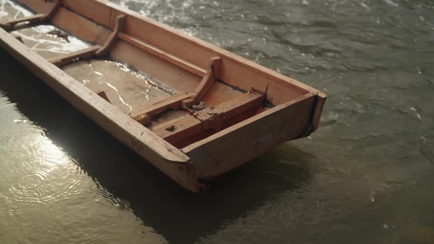 Wooden canoe floating on a river