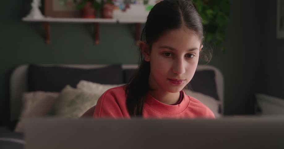 Portrait of a girl sitting in front of a laptop