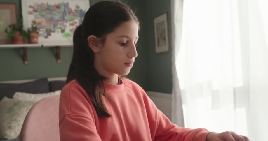 Girl sitting typing on a laptop