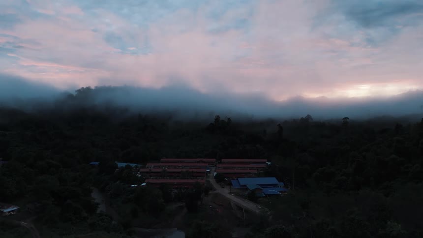 Aerial view of a rural community in the middle of a river and forest