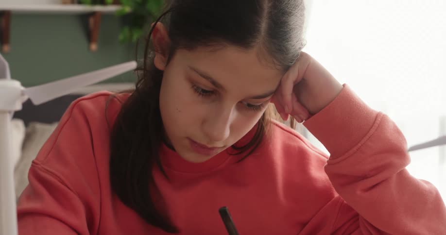 Woman sitting writing on a project