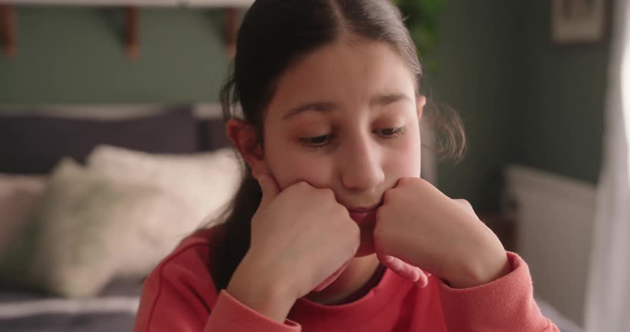Portrait of a thoughtful girl with palms on her face