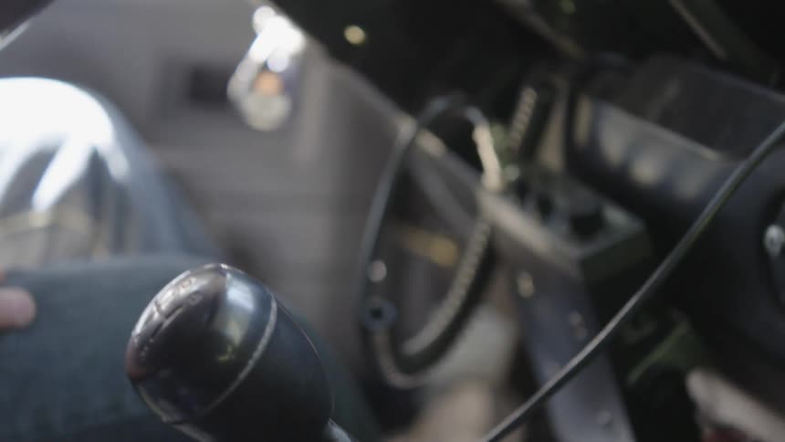 A person shifting gears
