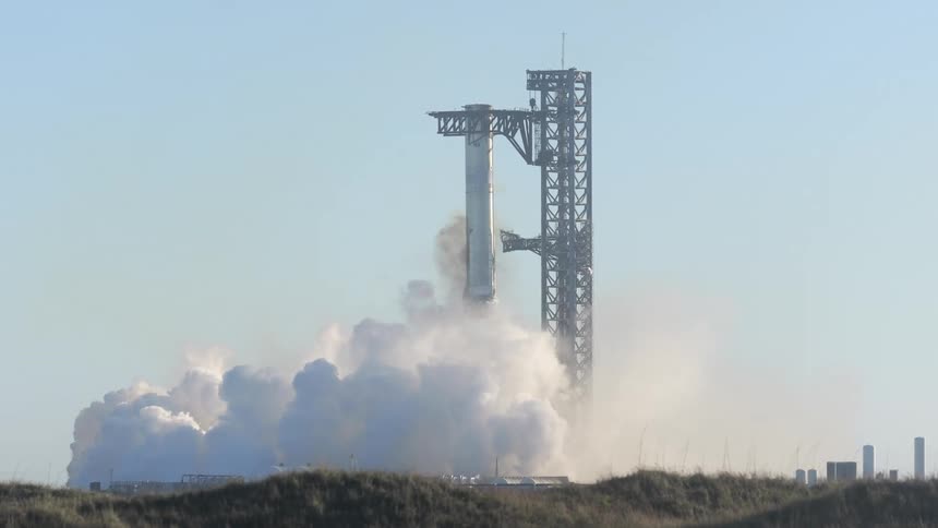 SpaceX Starship rocket booster landing and returning to platform with smoke and fire emitting