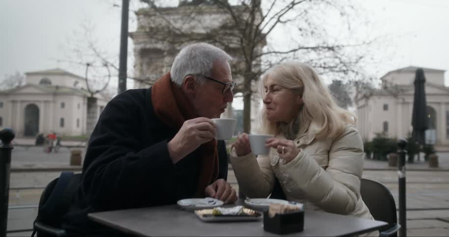 Romantic couple drinking coffee together and leaning their heads against each other