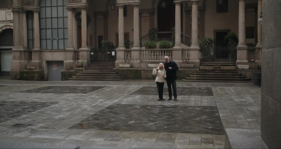 Two tourists hug while they take in the sites