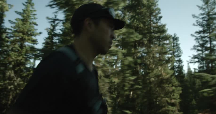 A man is going for a run through the forest