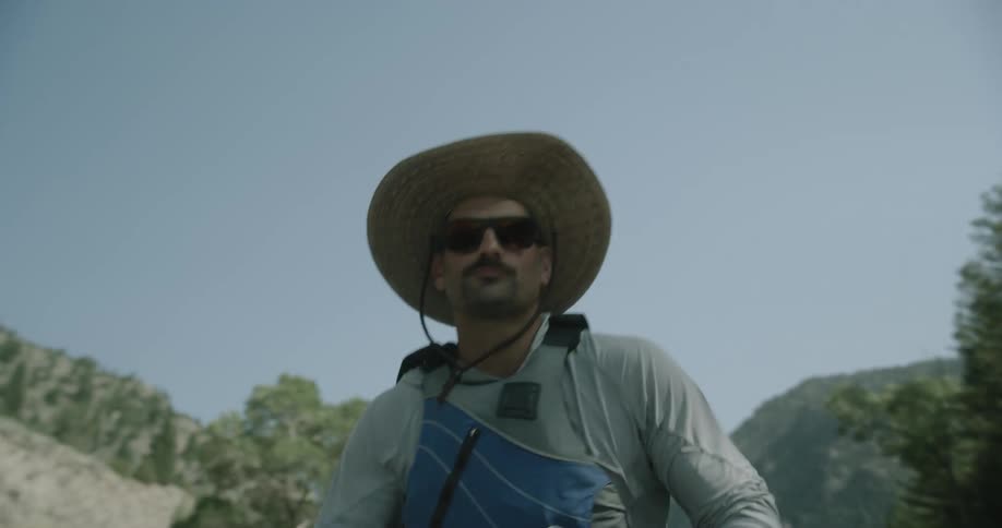 A man is paddling on a sunny day