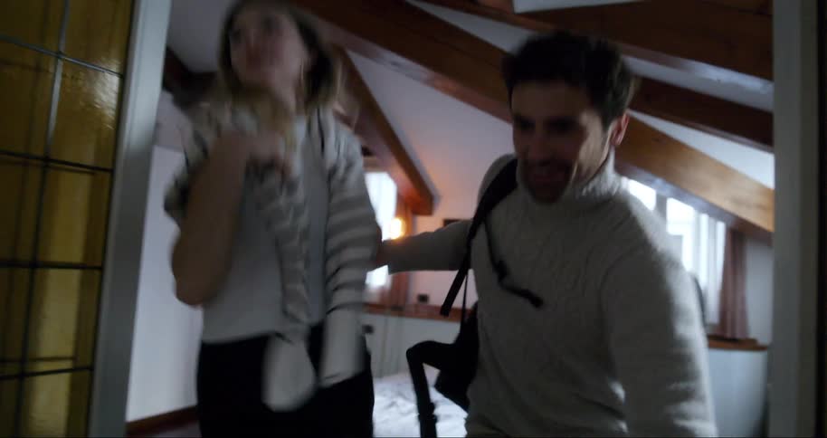 Woman and a man running out of a room
