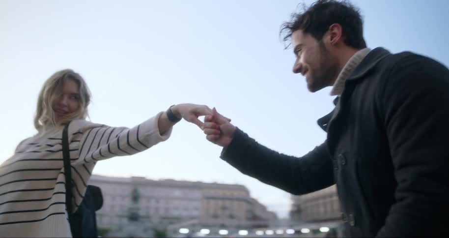 A man and woman dance in the street