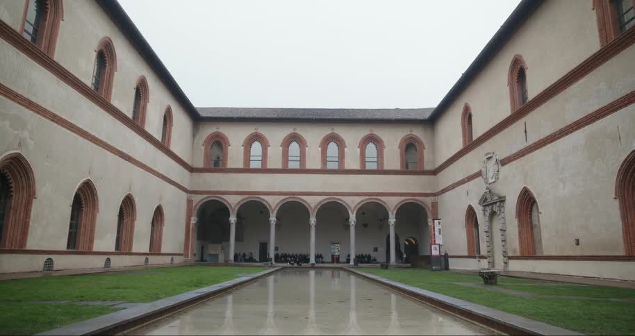 Inner courtyard of the sforzesco castle in milan with a water mirror reflecting the renaissance architecture
