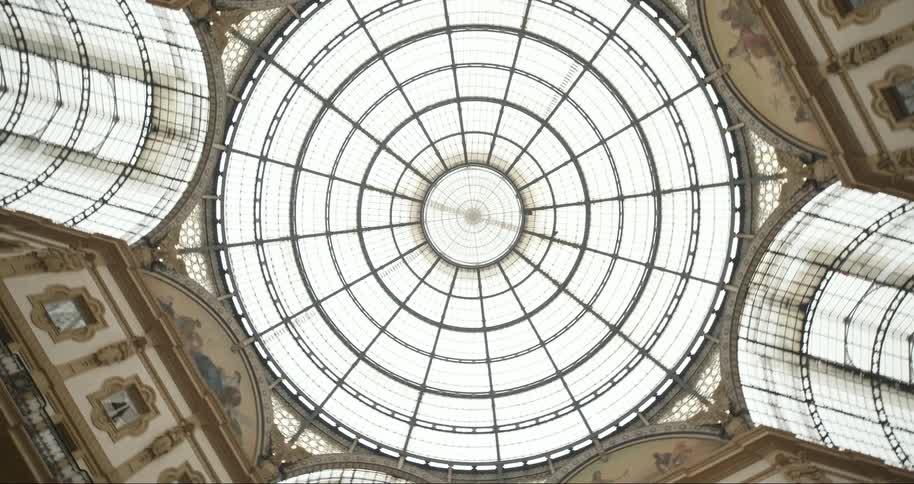 A view of an interior of a building with a glass skylight in the roof
