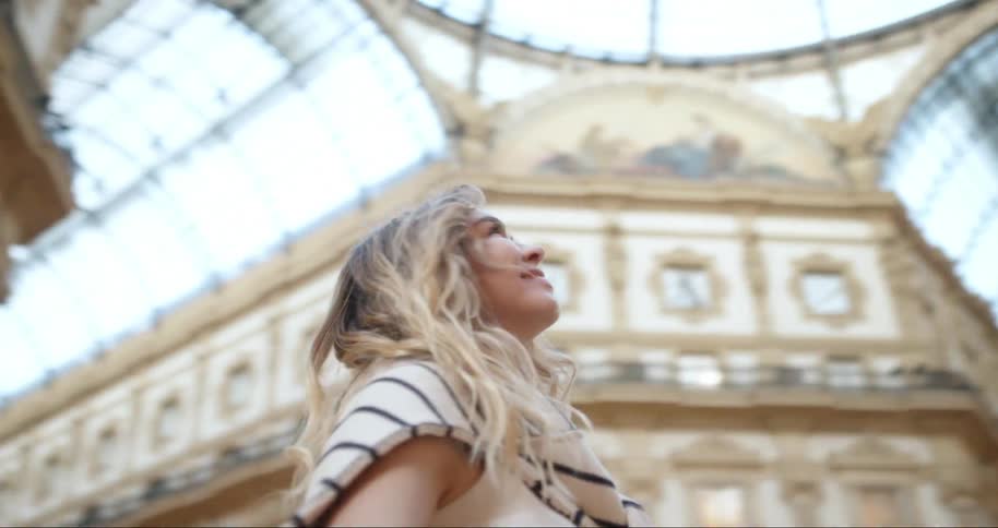 Portrait of a woman inside a classic building smiling