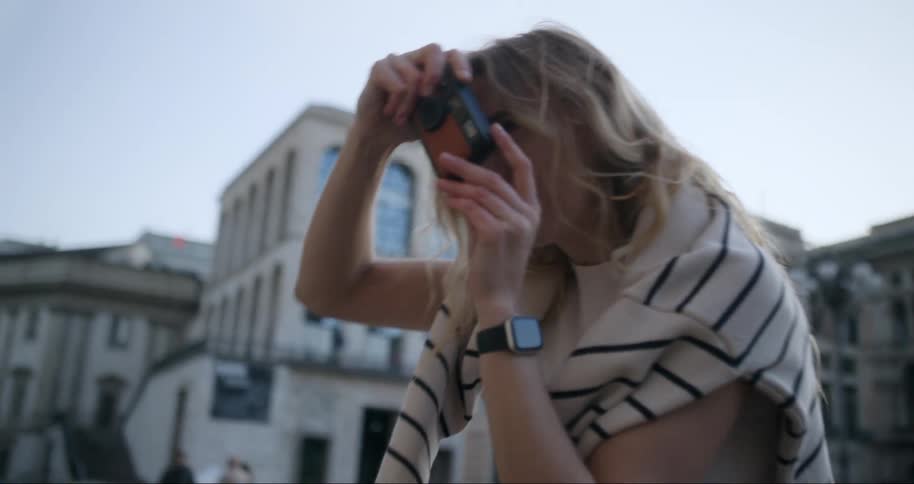 A tourist is taking pictures in the city