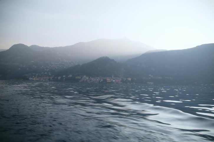 Motion in the ocean and mountains with a picturesque town in the background