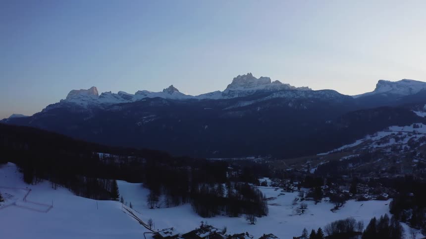 Aerial view of mountains with sparse vegetation and snow