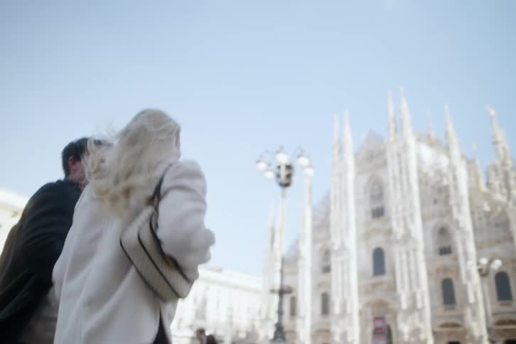 A man and woman sprint towards the cathedral