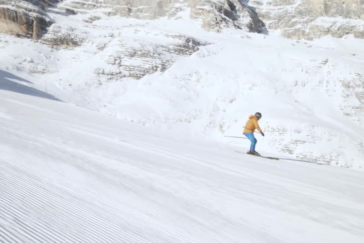 A man skis down the white slope