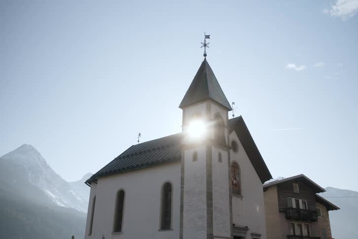 Sunlight shines through the bell tower of the church