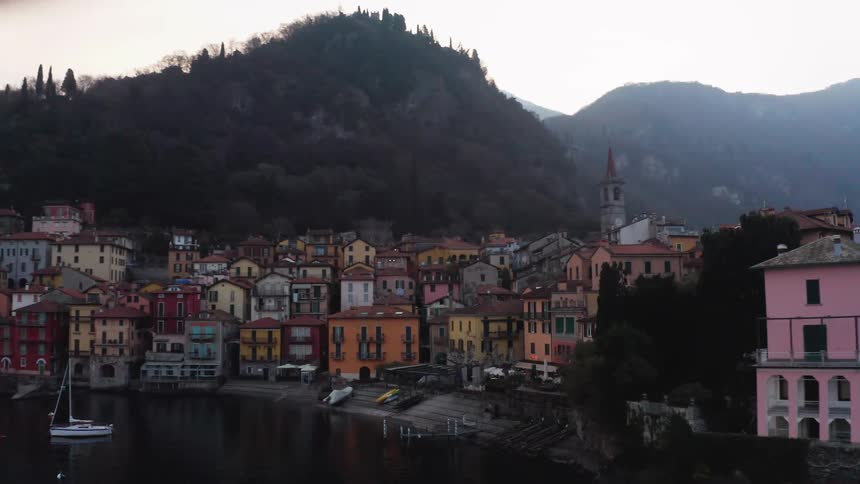 Village with classic and colorful buildings at the foot of a mountain by the sea