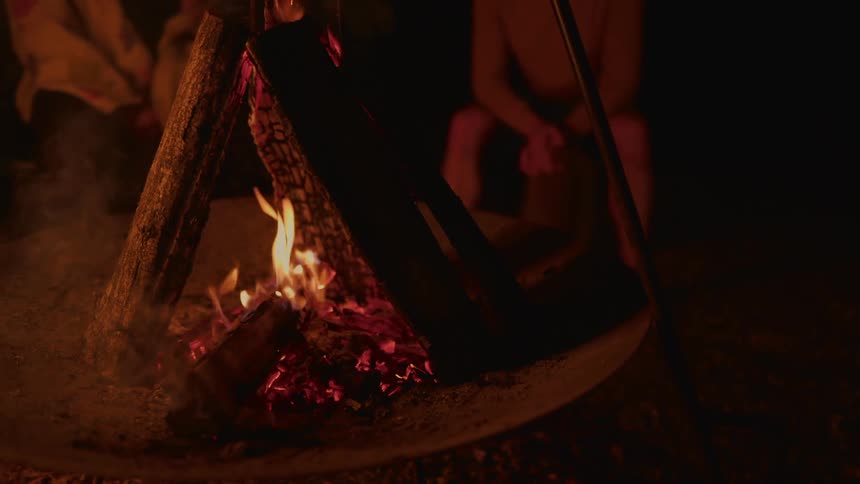 Fire lit at night with embers