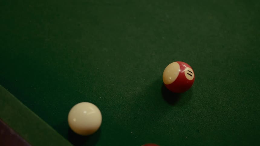 Snooker balls moving above a green table