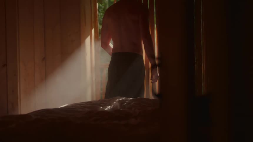 Man walks out onto his bedroom balcony on a sunny day