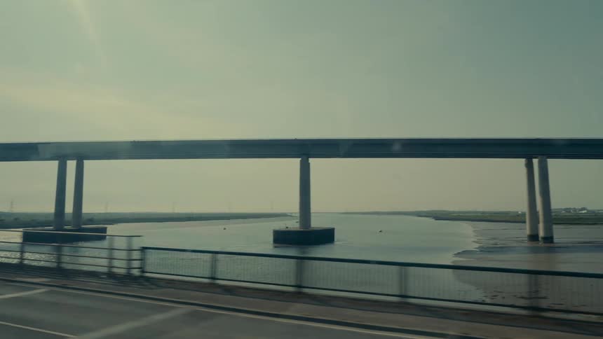 A large bridge is over the stream