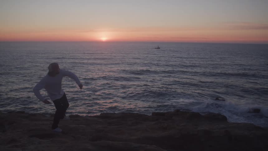 A footage of a person throwing an object into the sea