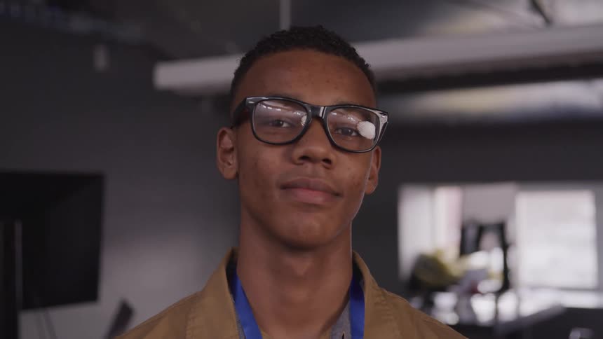 Portrait of a man with glasses in an indoor space