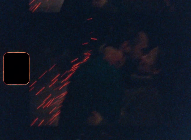 Couple kissing with fireworks in the background