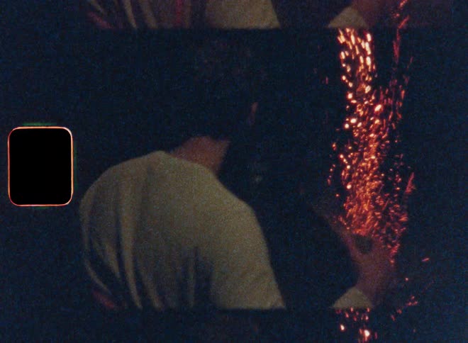 Couple hugs while watching fireworks launch at night