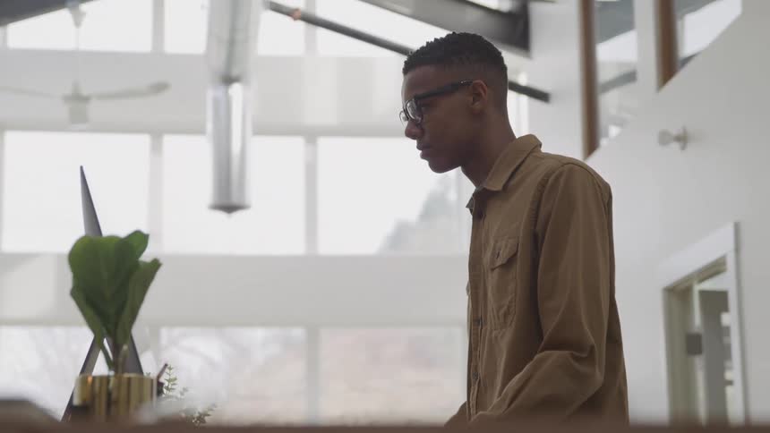 A man is looking at a large monitor