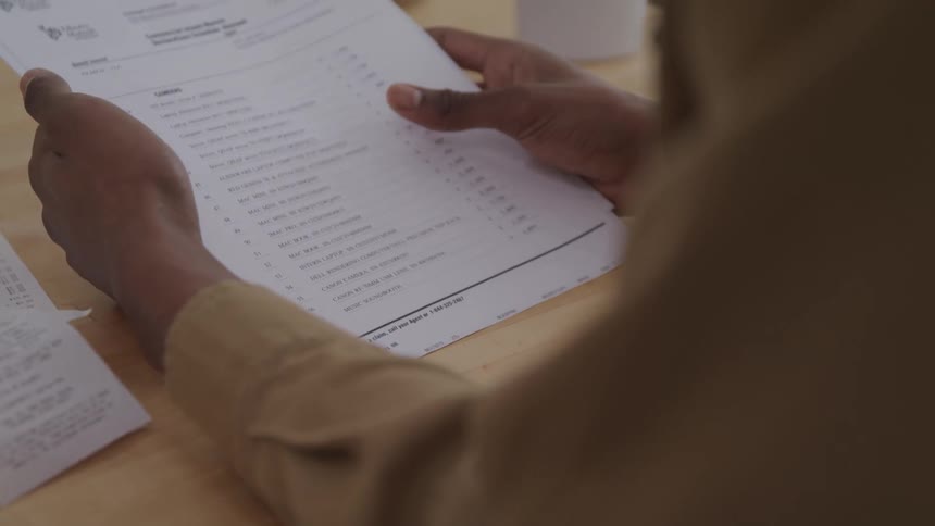 A clip of a person holding a document