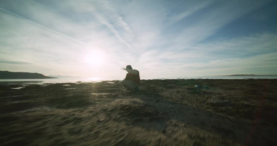 A footage of a person dancing by the seashore