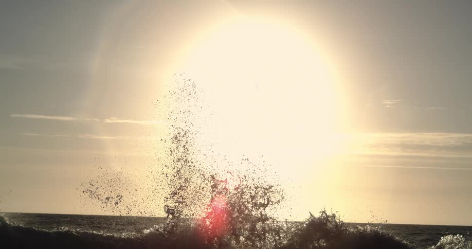 The rising sun fills the sky on the shore