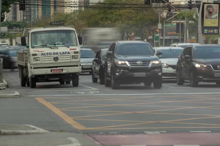 Traffic travels through a busy intersection downtown during the daytime