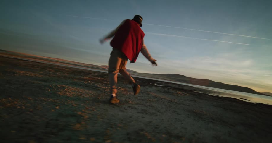 A footage of a man dancing by the coastal area
