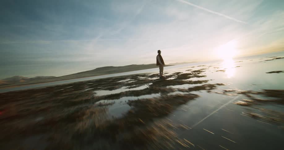 A footage of a person standing at the sea shore