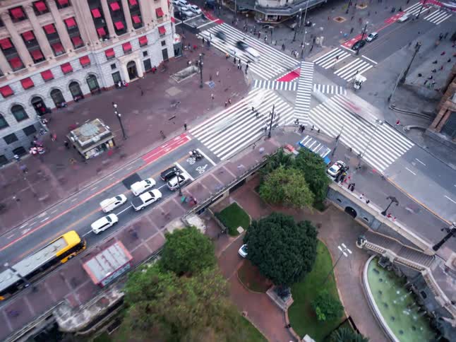 Pedestrians and vehicles travel through the intersection