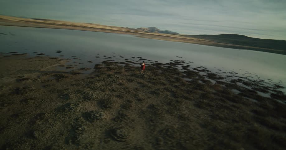 A man is dancing by the lake water