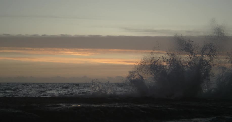 Waves break against rocks in the sea